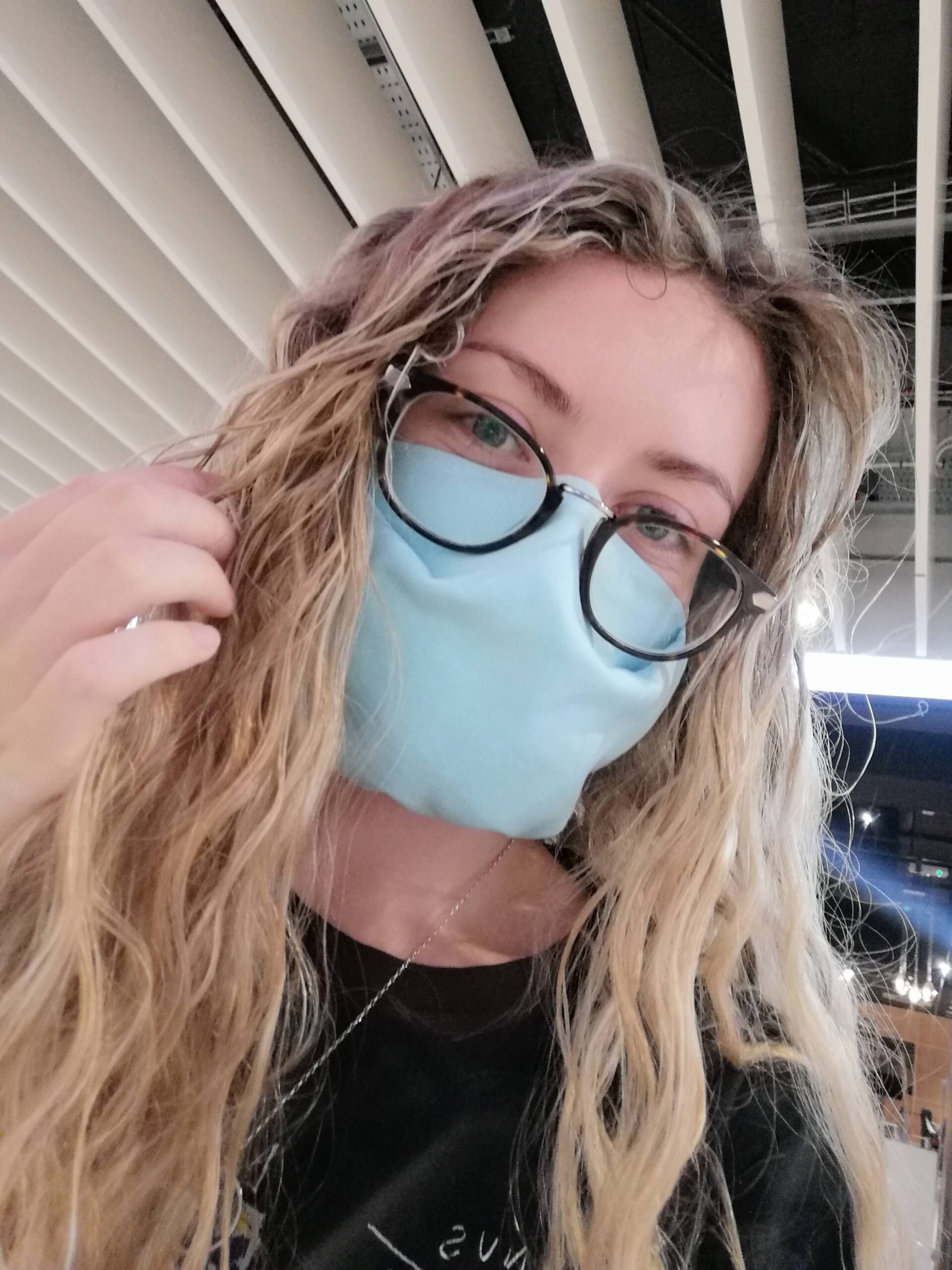 Holly in the airport wearing a face mask
