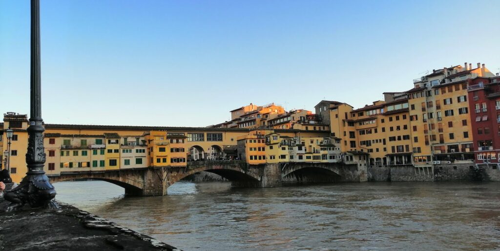 The Ponte Vecchio with the river and a lamppost in the foreground